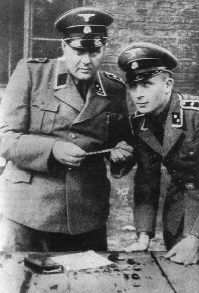 Two SS officers with confiscated Jewish property in the Lodz ghetto.